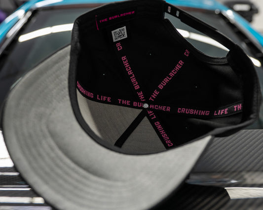 Black hat interior with red text on a reflective surface